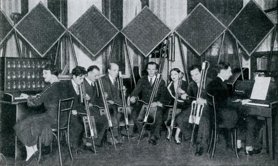 six theremin cello players, with Lev in the middle, and 2 keyboard theremins on both sides