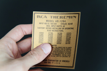 Hand holding a replica RCA Theremin License Notice